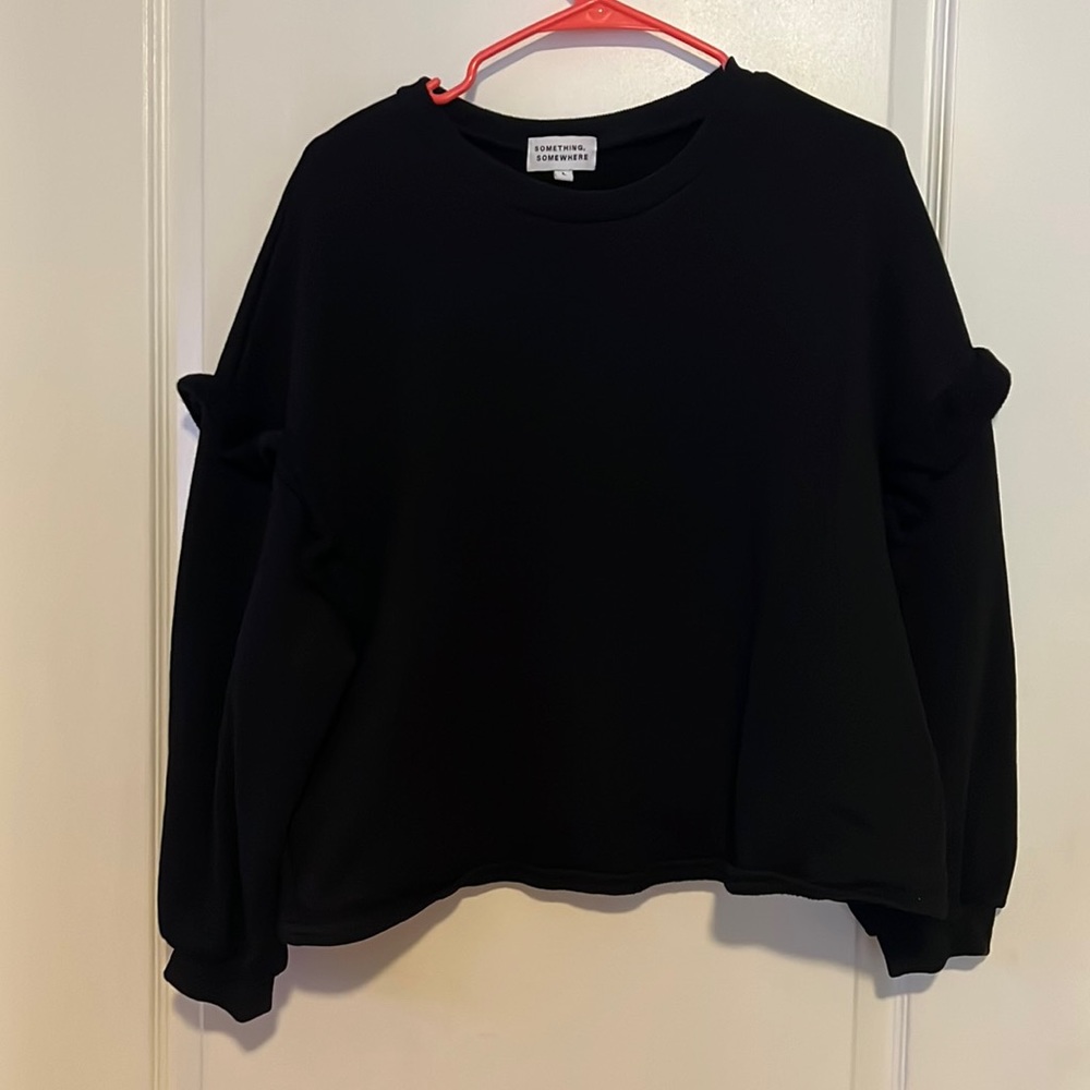 Black sweater with sleeve ruffle